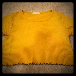 A mustard yellow cropped, bitter tee.
